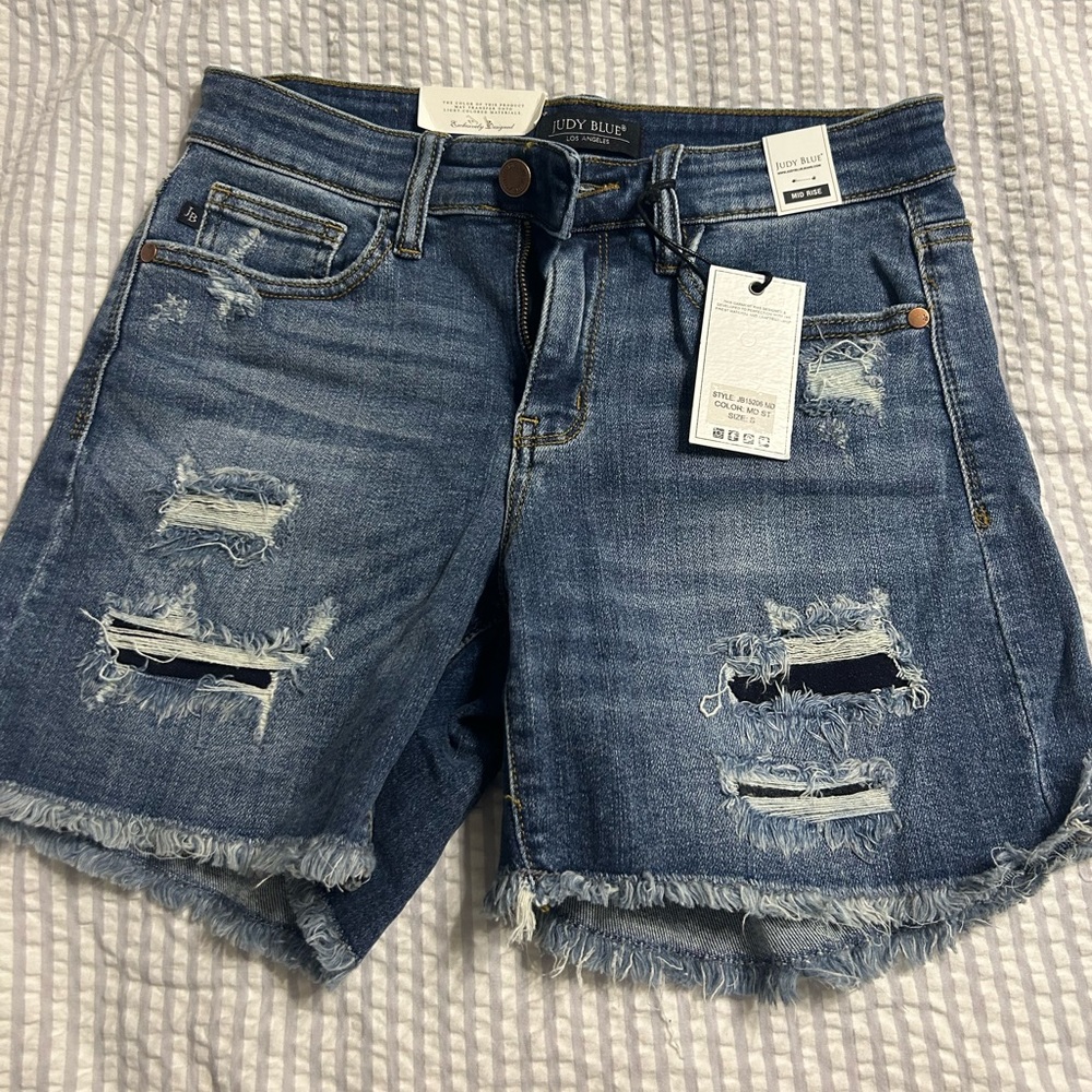 Small Judy blue mid rise jean shorts w patched holes